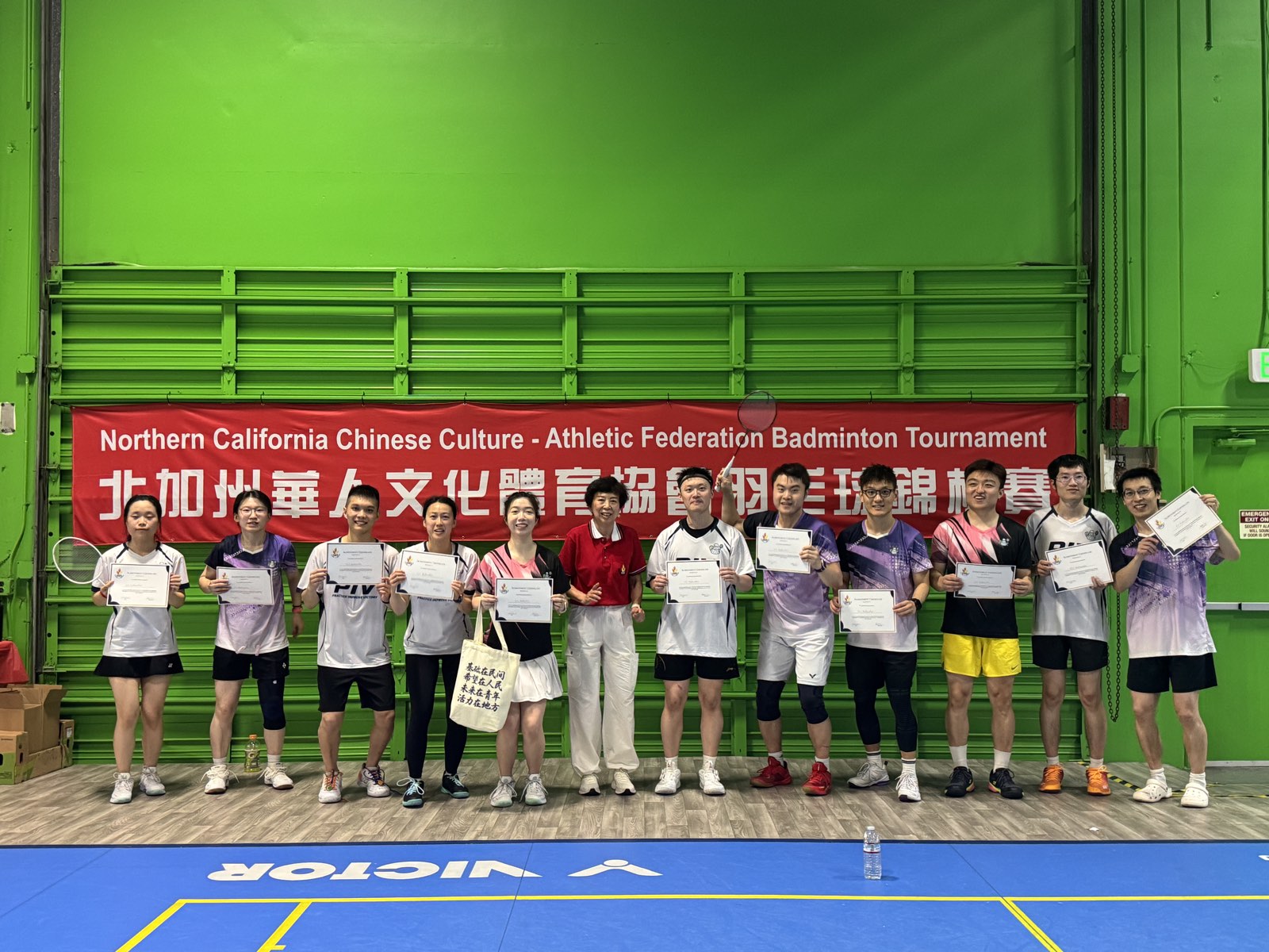 PIV runner-up team holding their certificates in front of the Northern California Chinese Culture Athletic Federation Badminton Tournament banner