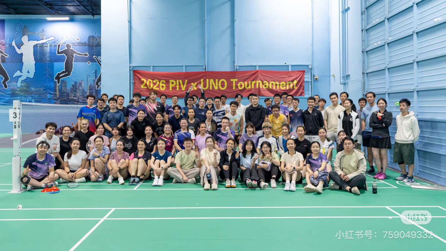 Players and volunteers gathered on court under the red "2026 PIV x UNO Tournament" banner at 21 Badminton Club in Fremont